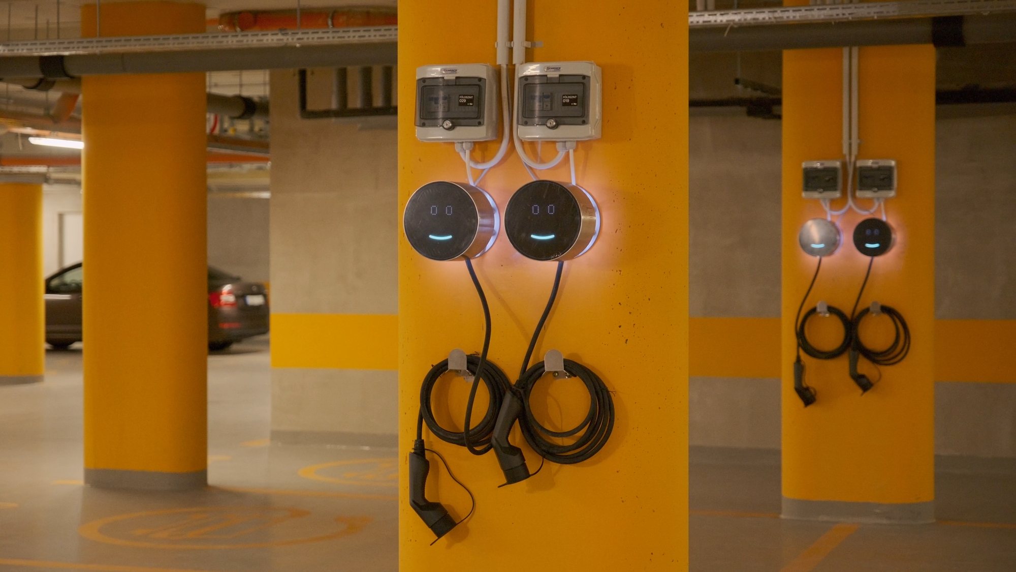 Two Voltie chargers on yellow garage columns