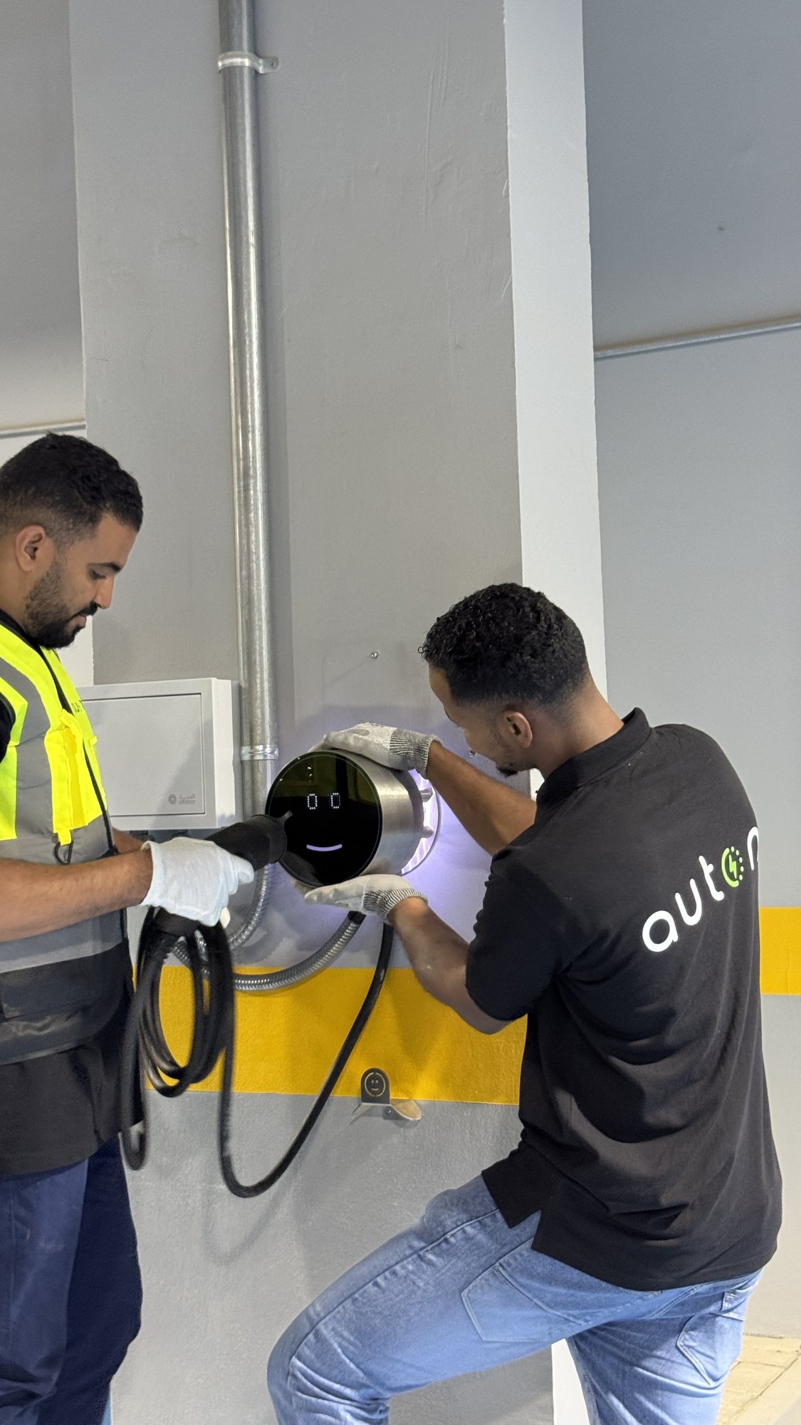 Auton installers fitting a wall charger