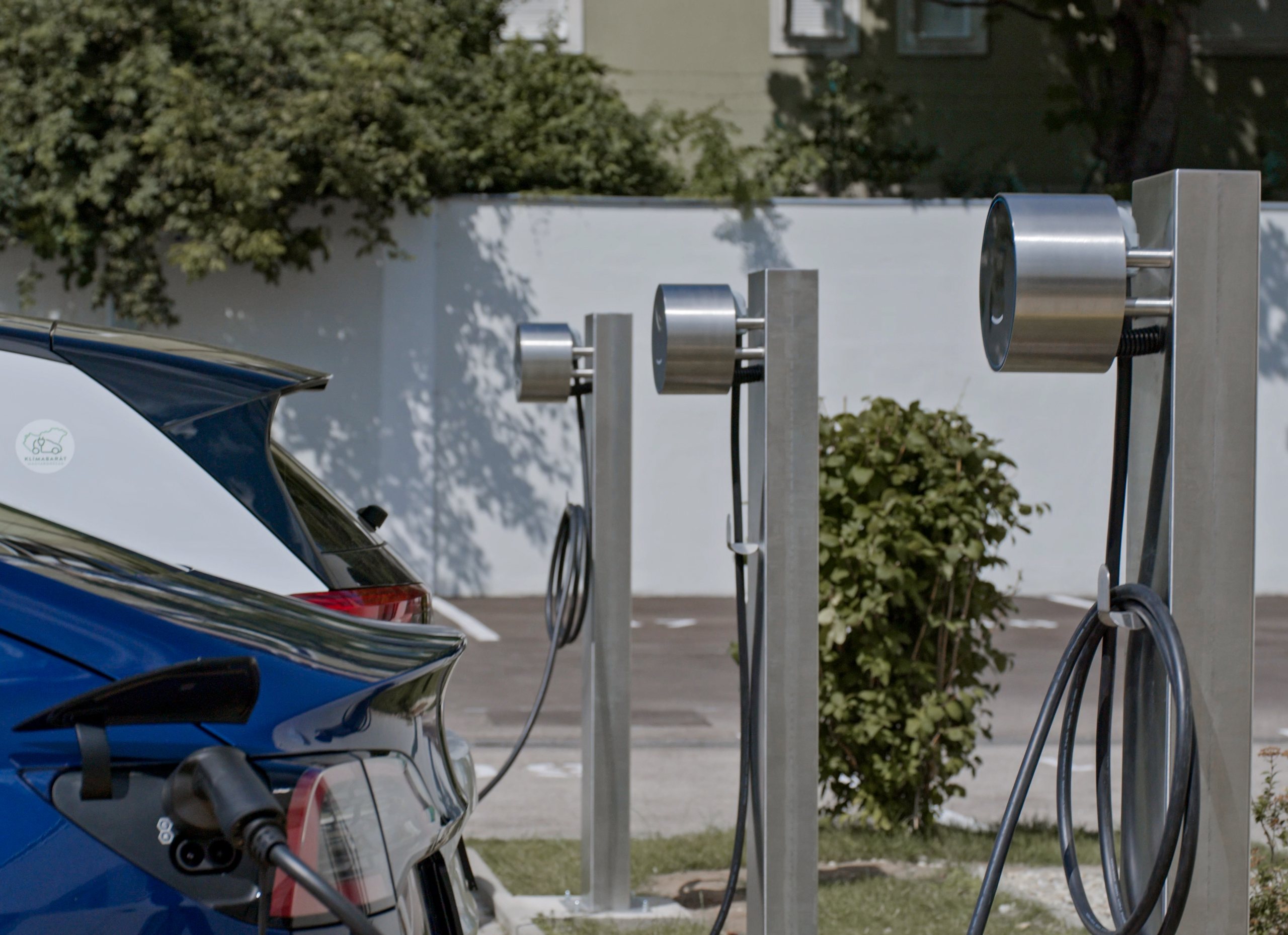 Voltie pedestal chargers beside an electric car